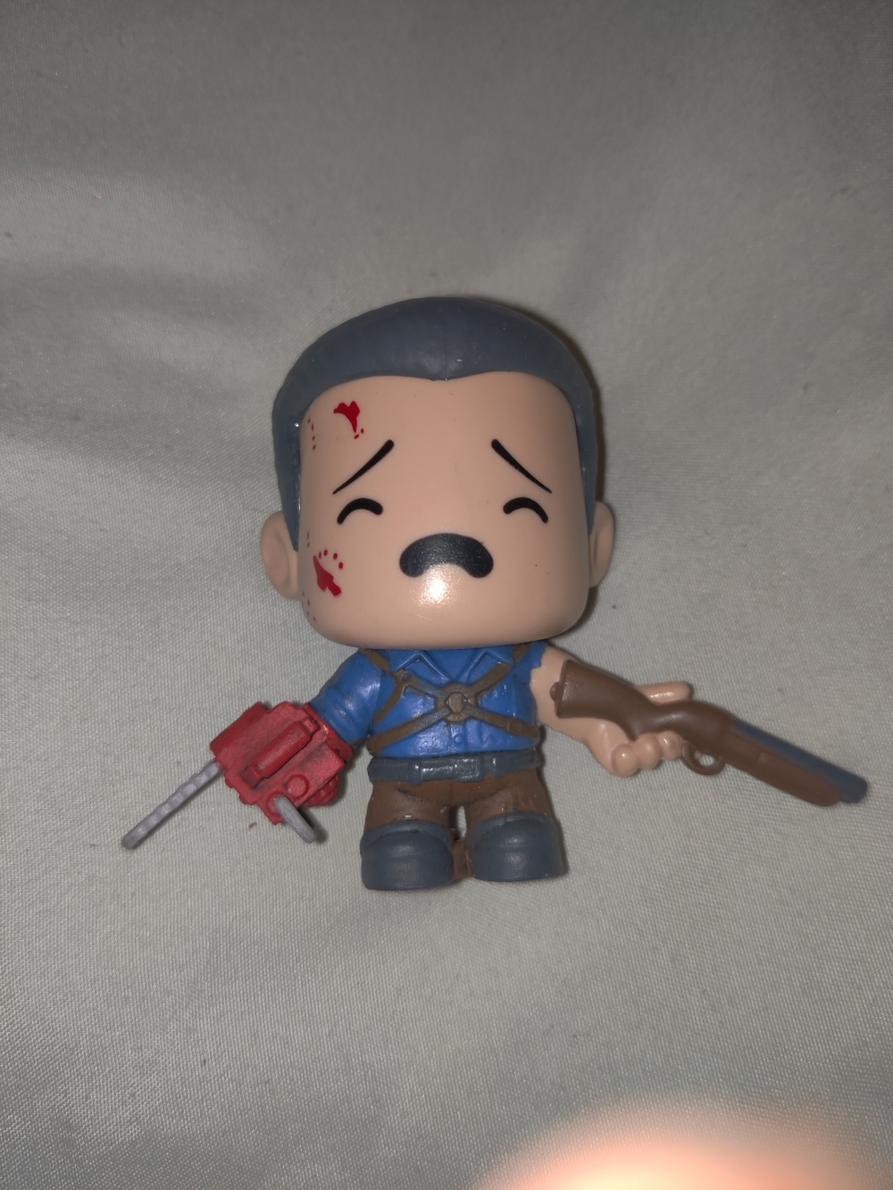 Loot Crate Blue-Clad Action Figure with Red Chainsaw and Brown Rifle
